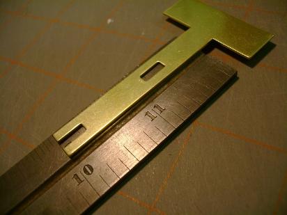 Frein is placed on a thick machinist's scale, 2 inches from the end.